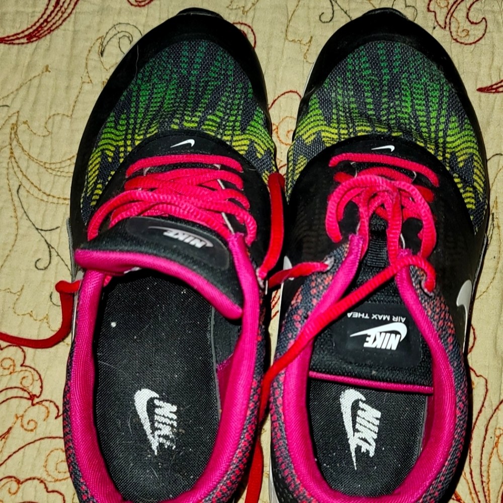 Nike size 9 women's pink and black shoes small spot in front-toe separation.